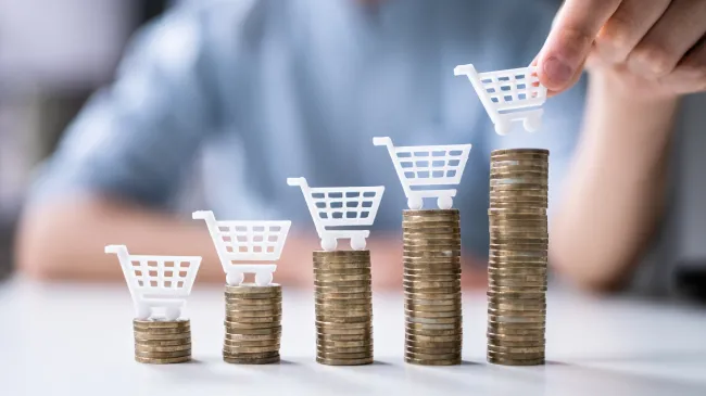 inflation grocery carts on rising coin stacks